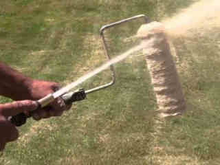 Removing excess paint using a pressure hose.