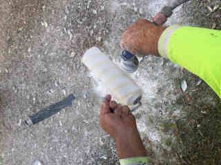 Spinning paint from the roller using a hose attachment.