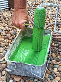 2: Recover paint by scraping the roller into a tray. 